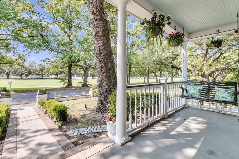 Tucked beneath a canopy of sweeping live oaks, this beautifully - photo 6