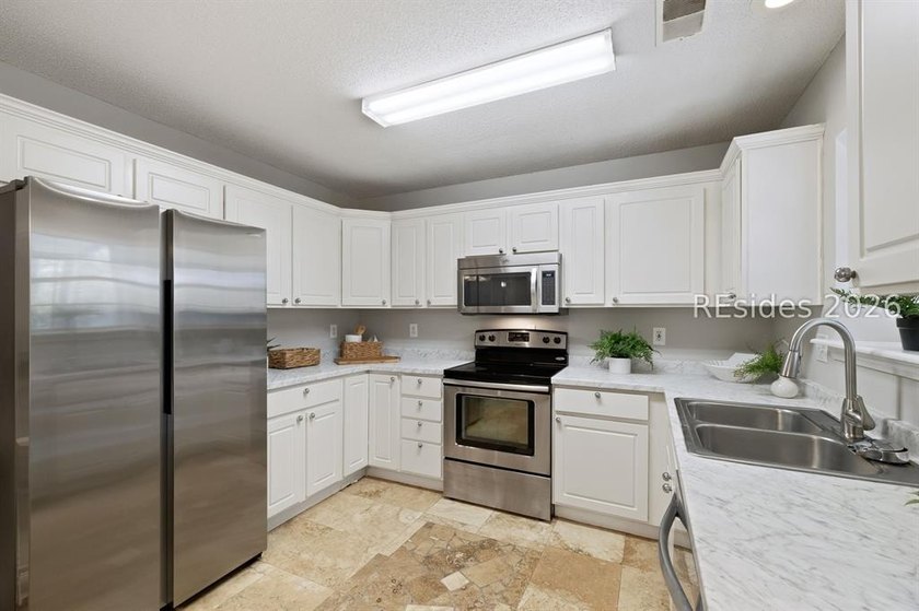 Freshly updated, this 4BR/2BA home located in The Farm offers a - photo 10