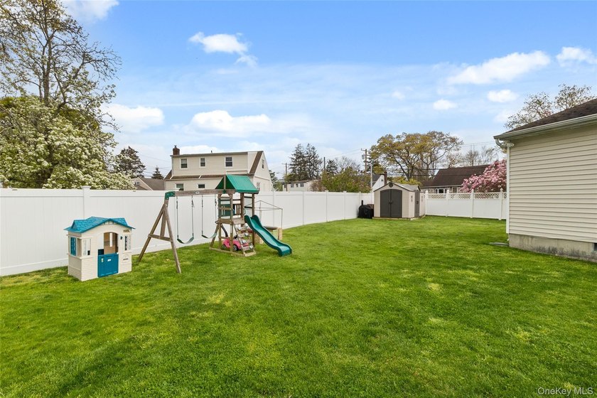 This beautifully renovated Colonial in East Islip sits on an - photo 21