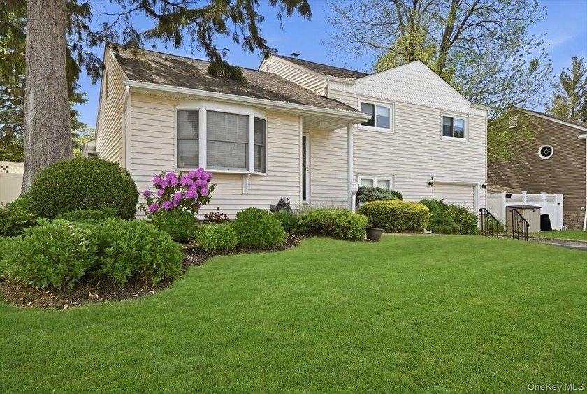 A charming expanded 3-bedroom, 2.5-bath split-level home located - photo 2