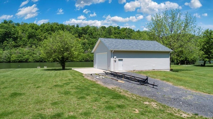 Enjoy nearly an acre of level waterfront property where the - photo 3