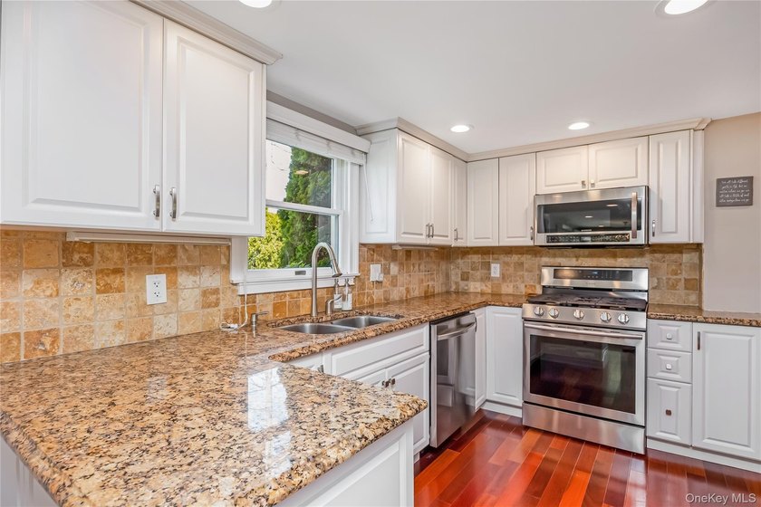 Welcome to this beautifully updated expanded Cape nestled in the - photo 7