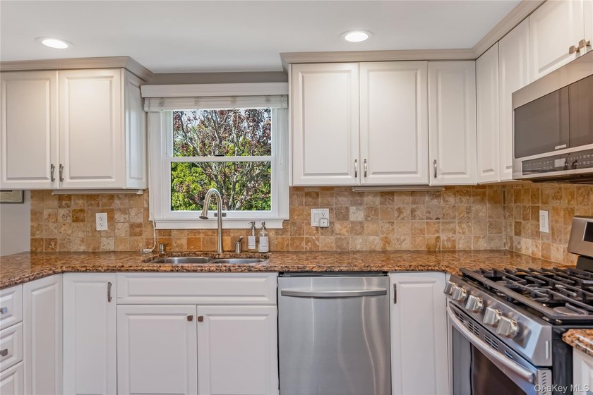 Welcome to this beautifully updated expanded Cape nestled in the - photo 8