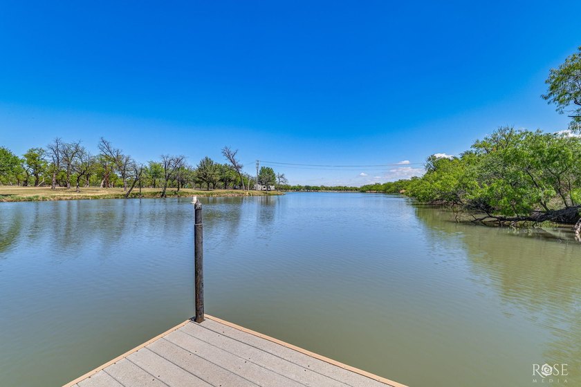 Perched above the tranquil waters of Lake Nasworthy just outside - photo 60