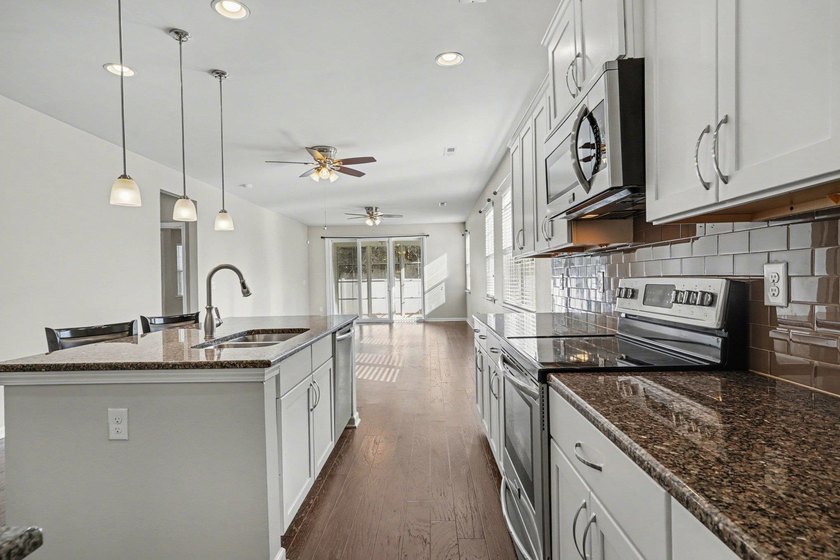 This well-designed three-bedroom, two-bathroom home features an - photo 6