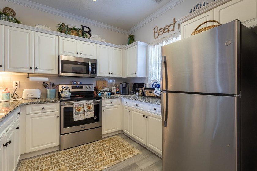 This well-maintained 2-bedroom, 2-bath condo offers a - photo 9