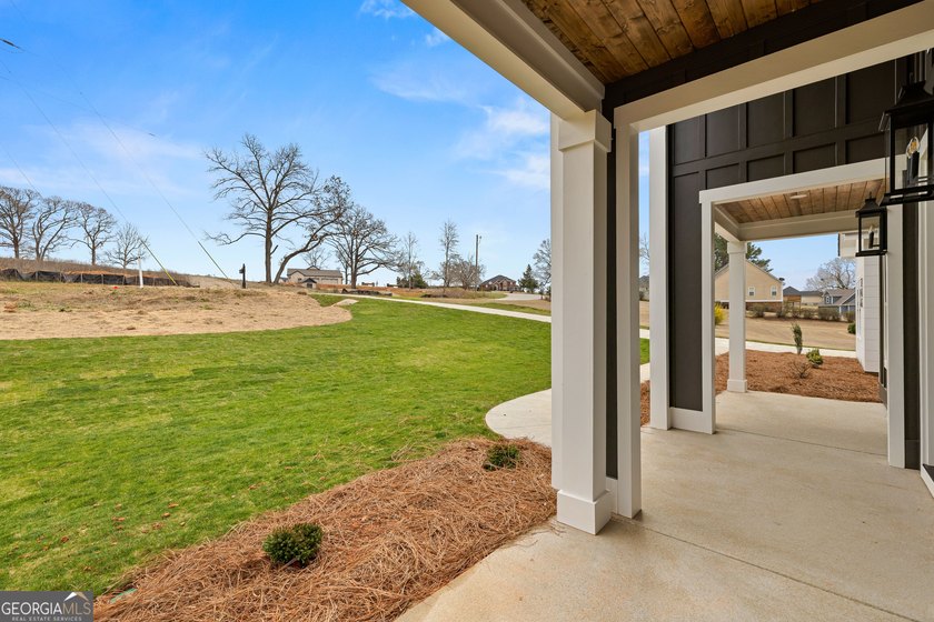 Stunning new construction overlooking a private lake, offering a - photo 4