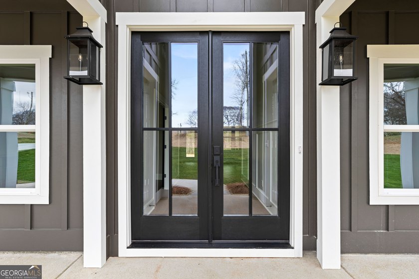 Stunning new construction overlooking a private lake, offering a - photo 5