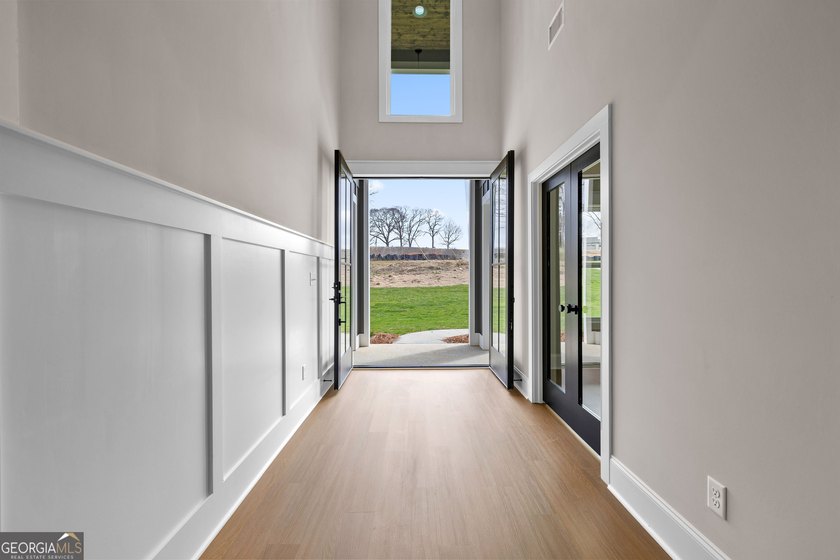 Stunning new construction overlooking a private lake, offering a - photo 6