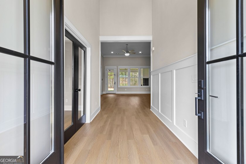 Stunning new construction overlooking a private lake, offering a - photo 8