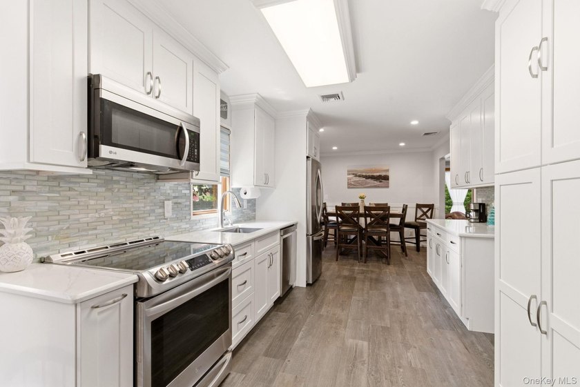 Welcome to this beautifully updated L-Shaped Ranch nestled in - photo 9