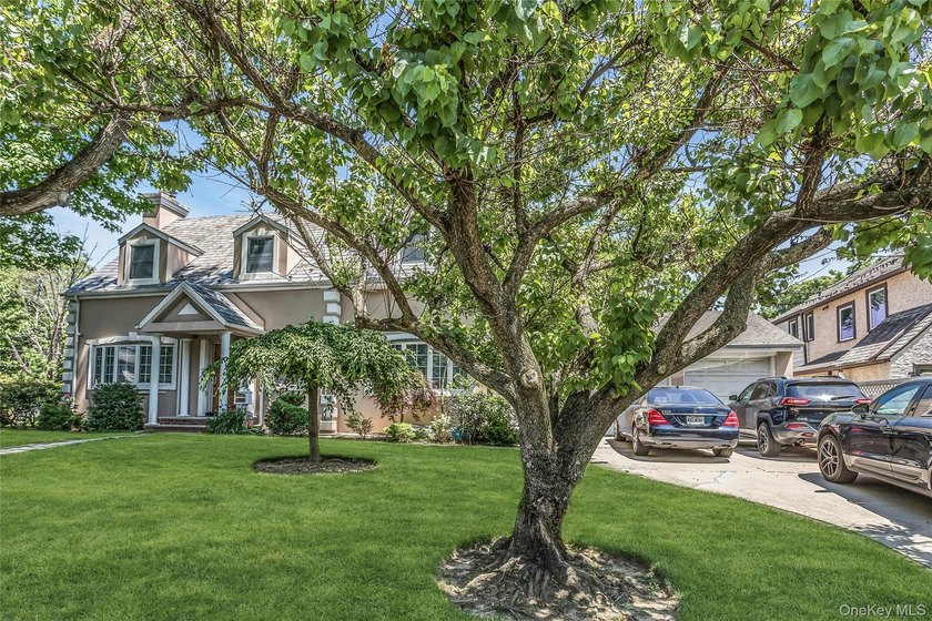 Set on a manicured corner lot in Bayside, this expanded Colonial - photo 2