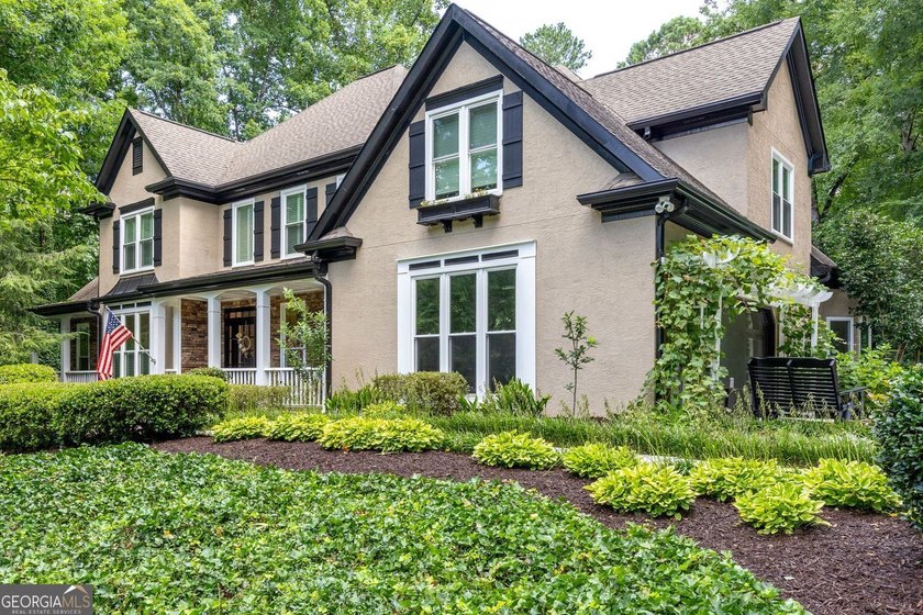 Tucked away on a beautifully landscaped lot of over 1 acre, this - photo 2