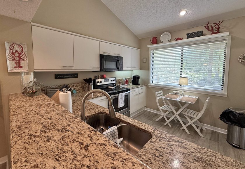 Updated and attractive second-floor end-unit villa featuring two - photo 21