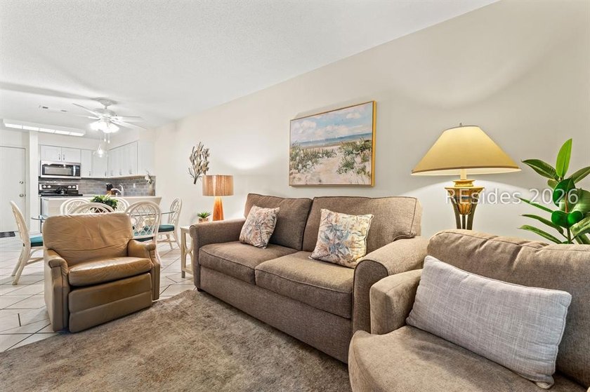 Tucked among mature landscaping in the highly desirable gated - photo 12