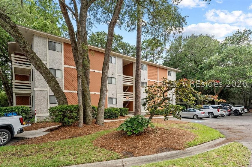Tucked among mature landscaping in the highly desirable gated - photo 24
