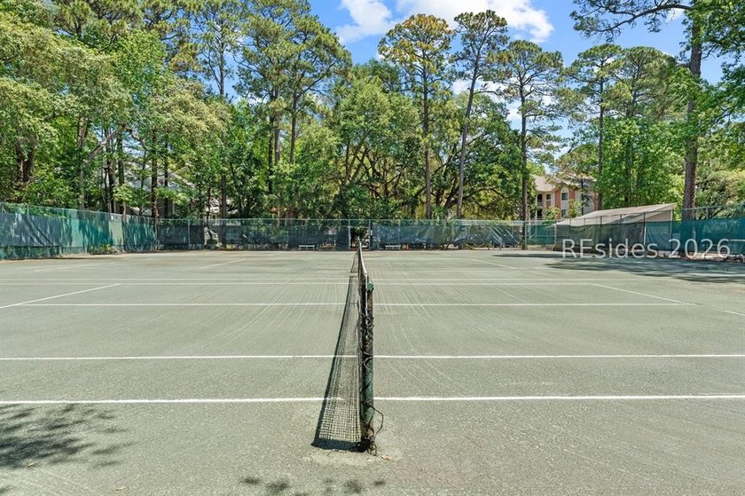 Tucked among mature landscaping in the highly desirable gated - photo 25