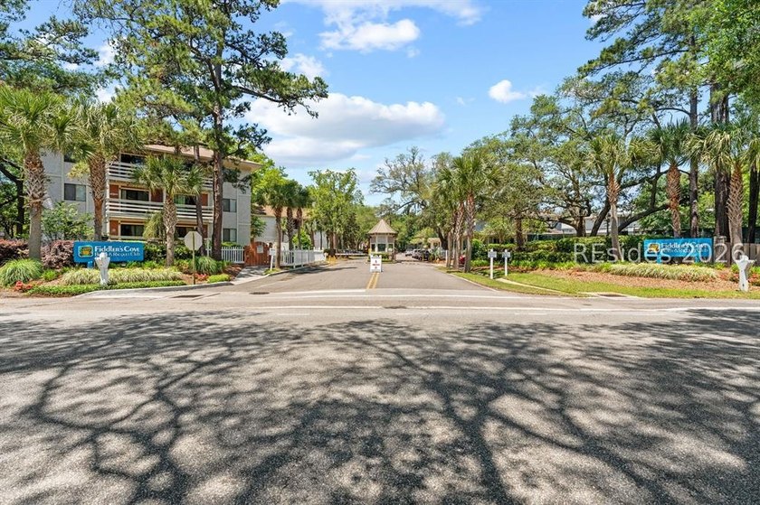 Tucked among mature landscaping in the highly desirable gated - photo 27