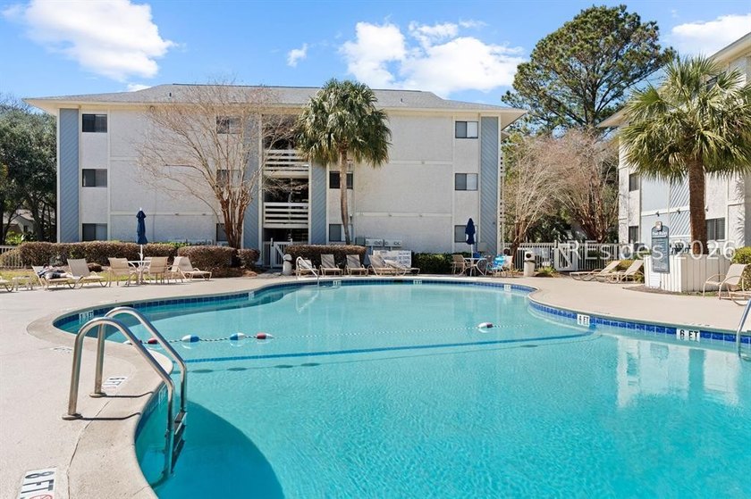 Tucked among mature landscaping in the highly desirable gated - photo 29