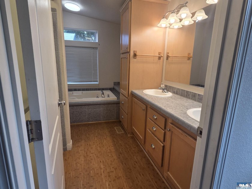 Space and natural light abound in this beautifully maintained - photo 18