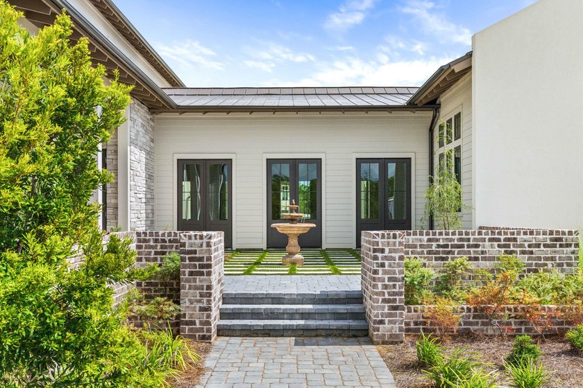 A showstopper of modern coastal elegance, 36 Sandcord Drive is a - photo 8