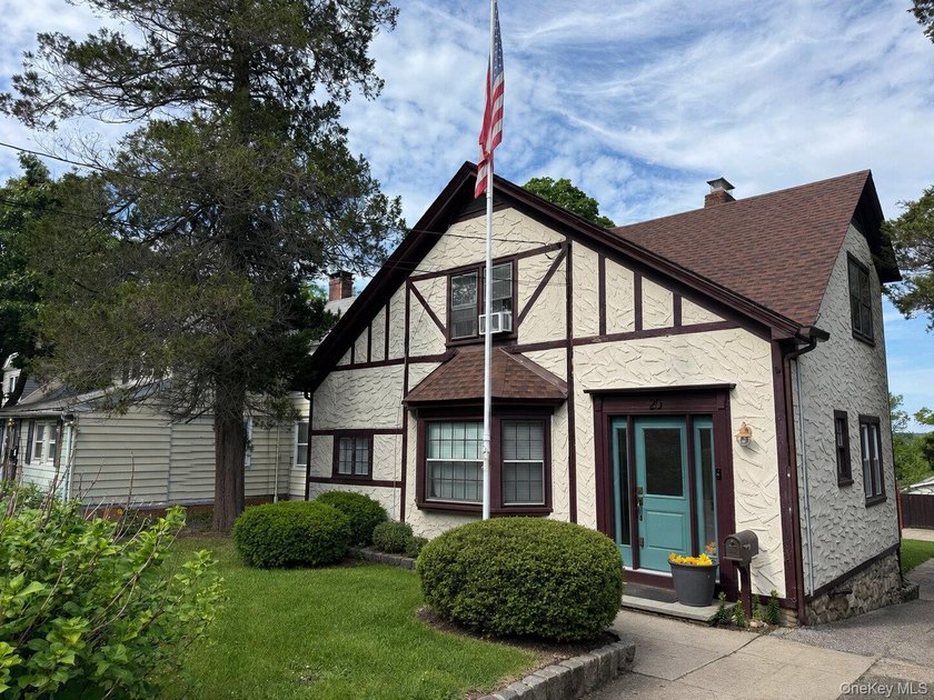 Picture-perfect 3-bedroom, 1.5-bath Tudor set on a tree-lined - photo 2