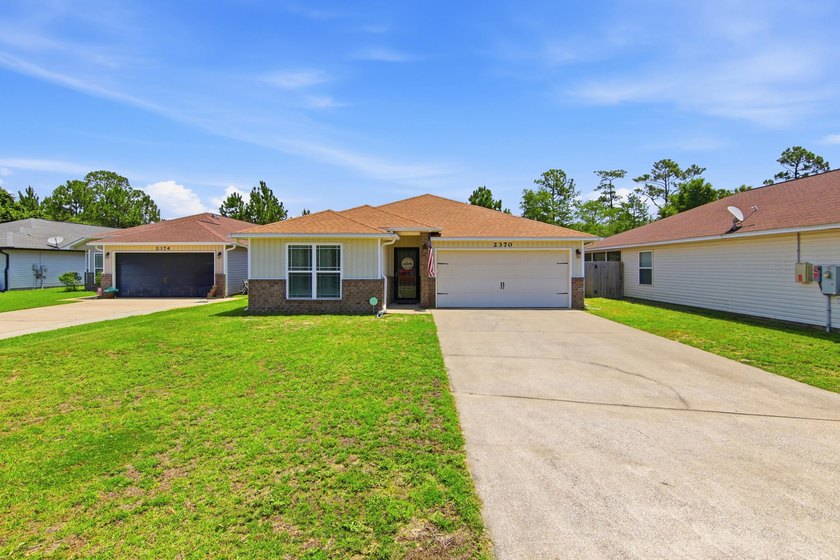 Located in the Duncan Ridge community of Navarre, this 3-bedroom - photo 2