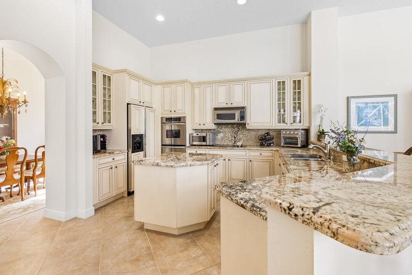Discover luxury living in Palm Cove Golf &amp; Yacht Club in this - photo 20