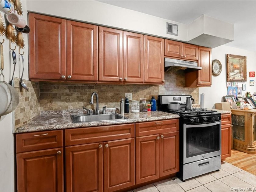 This three-story brick two-family home in Cypress Hills features - photo 5