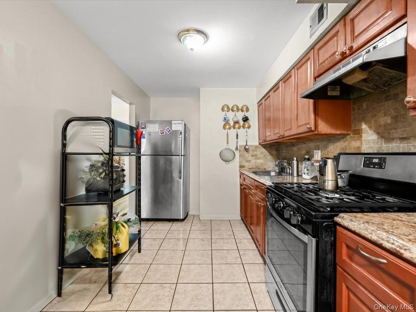 This three-story brick two-family home in Cypress Hills features - photo 6
