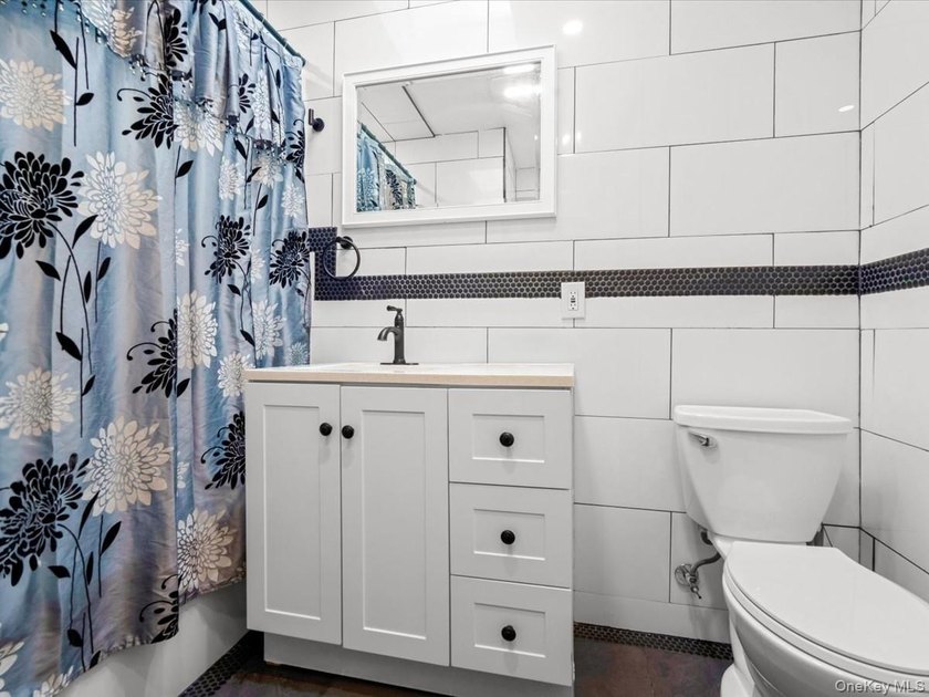 This three-story brick two-family home in Cypress Hills features - photo 7
