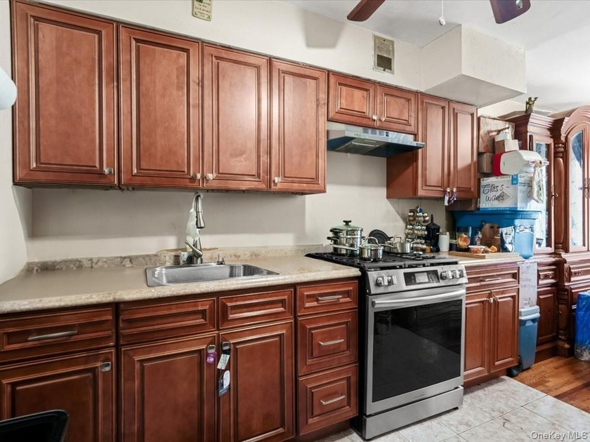 This three-story brick two-family home in Cypress Hills features - photo 9