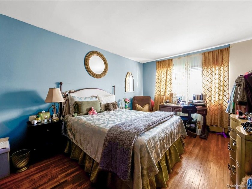 This three-story brick two-family home in Cypress Hills features - photo 10