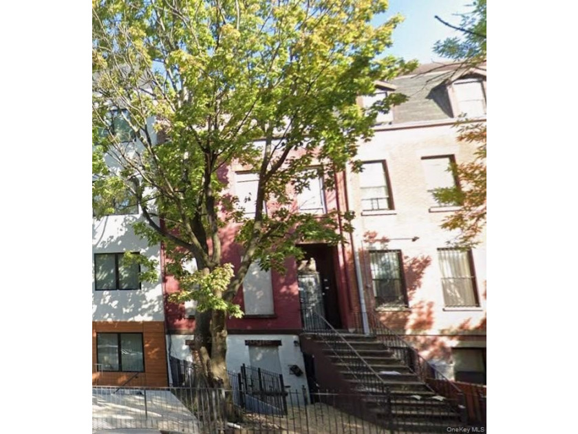 This four-story all-brick brownstone is full of potential and - photo 2