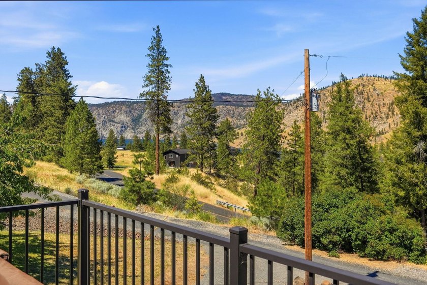 Situated on a sprawling 23-acre property along the serene shores - photo 26