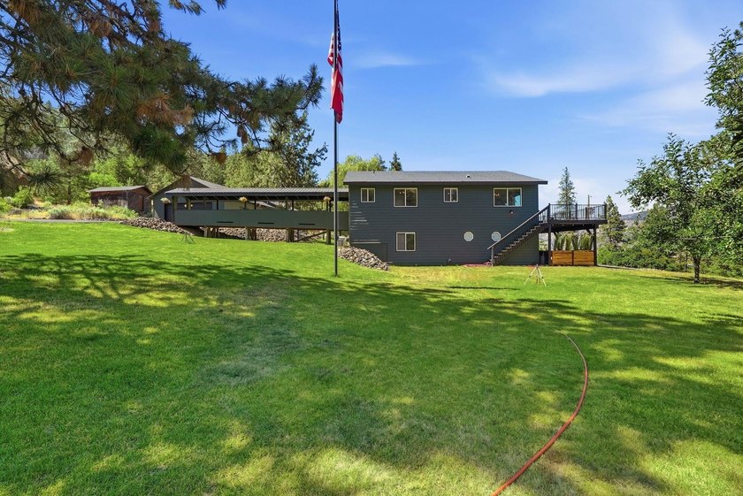 Situated on a sprawling 23-acre property along the serene shores - photo 28