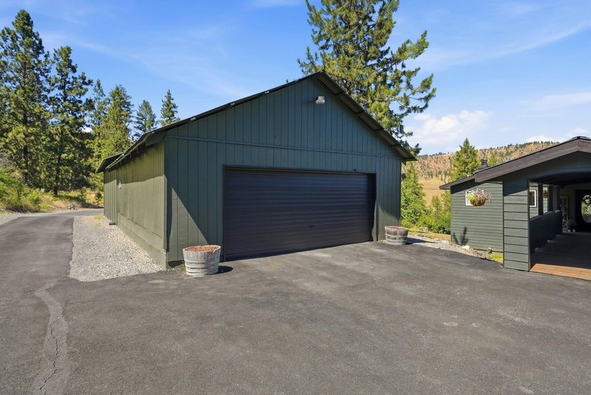 Situated on a sprawling 23-acre property along the serene shores - photo 29