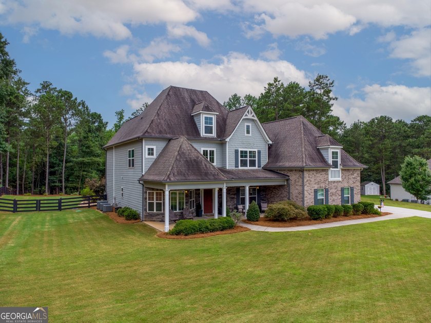 Welcome to 122 Brooks Landing, an exceptional 5-bedroom, 5 - photo 2