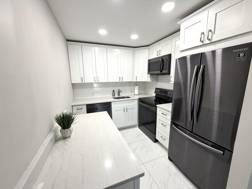 Tastefully updated condo located in a desirable 55+ gated - photo 4