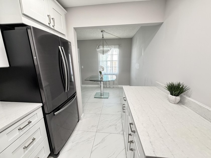 Tastefully updated condo located in a desirable 55+ gated - photo 7