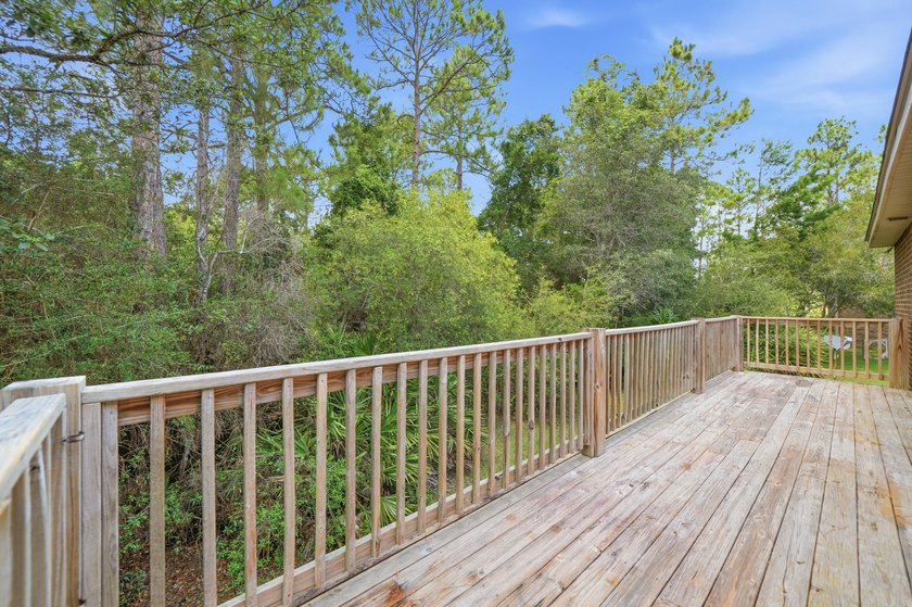 Set on a huge 0.52 acre lot with peaceful forest views, this - photo 4