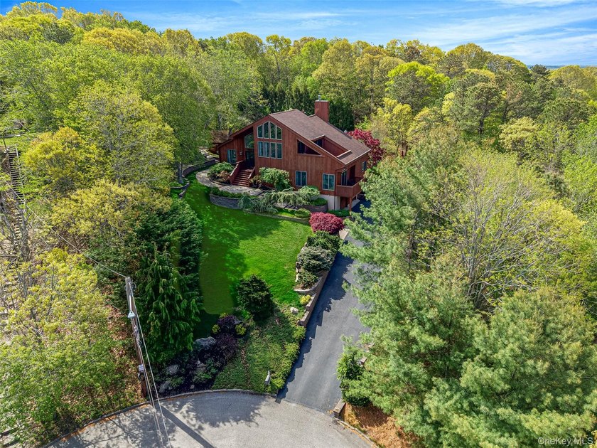 Set within the quiet Rolling Woods neighborhood on a shy acre at - photo 4