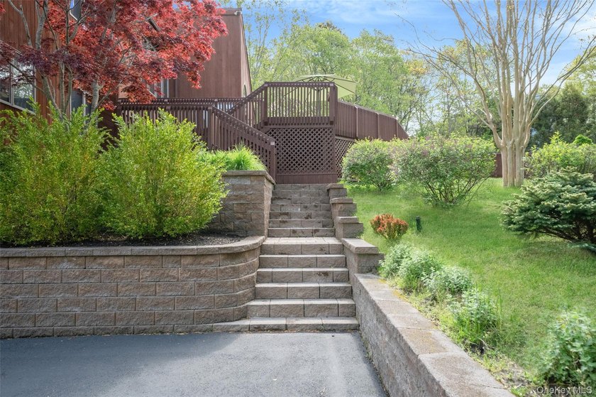 Set within the quiet Rolling Woods neighborhood on a shy acre at - photo 9