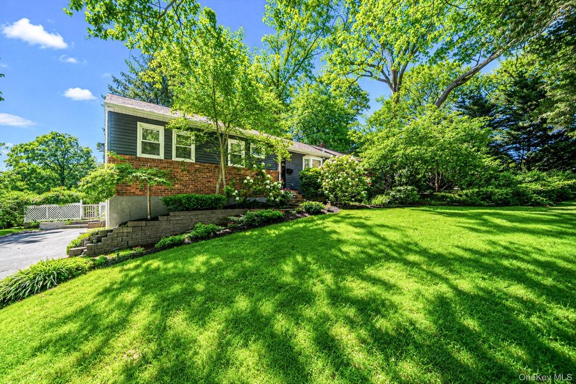 Nestled on a beautifully landscaped property surrounded by - photo 2