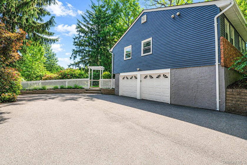 Nestled on a beautifully landscaped property surrounded by - photo 3
