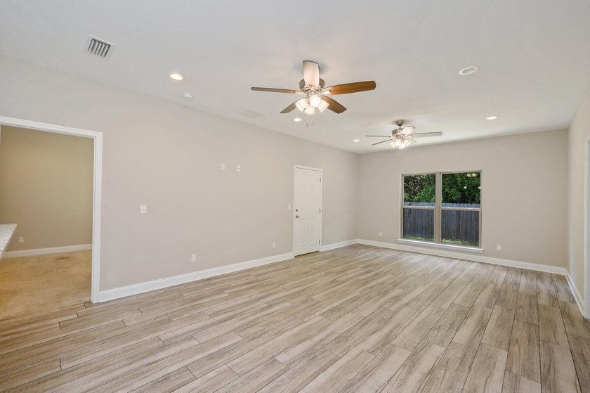 As you step inside, you are greeted with an open floor plan that - photo 6