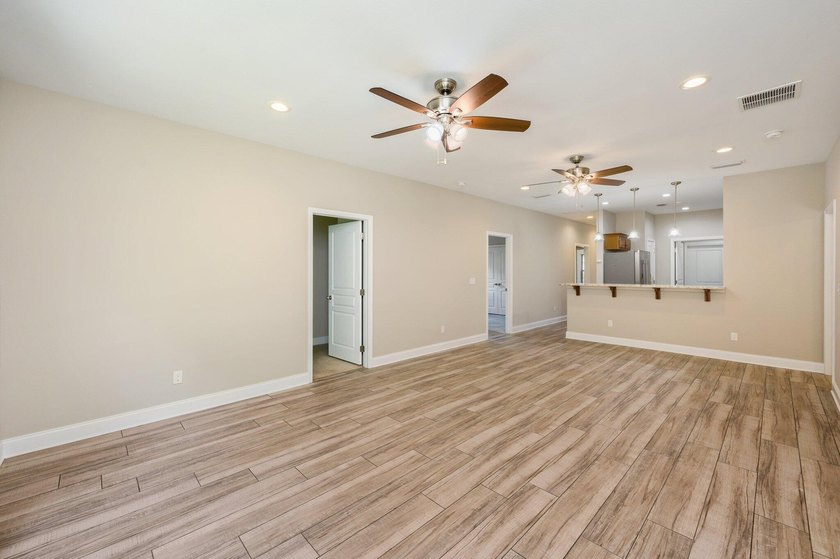 As you step inside, you are greeted with an open floor plan that - photo 8