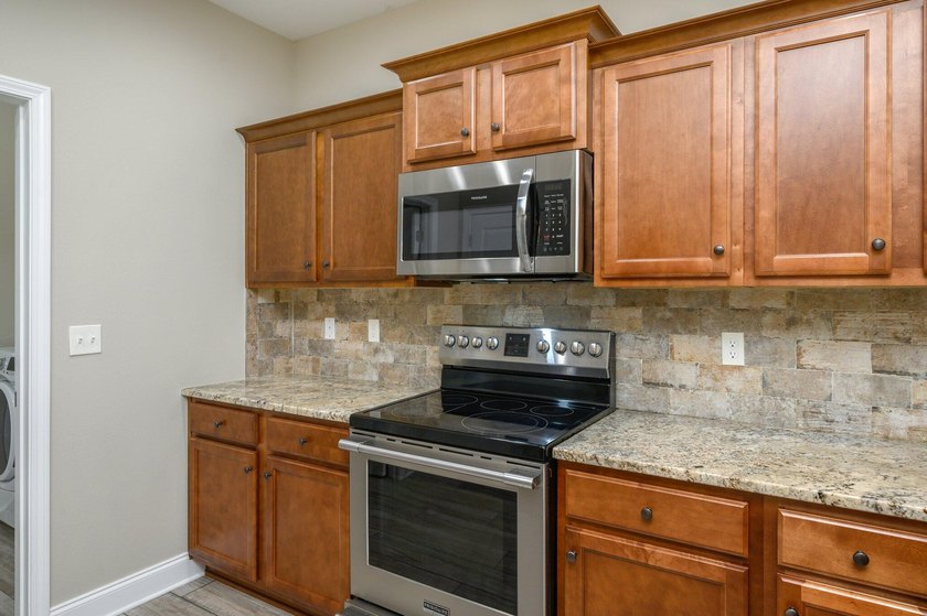 As you step inside, you are greeted with an open floor plan that - photo 10