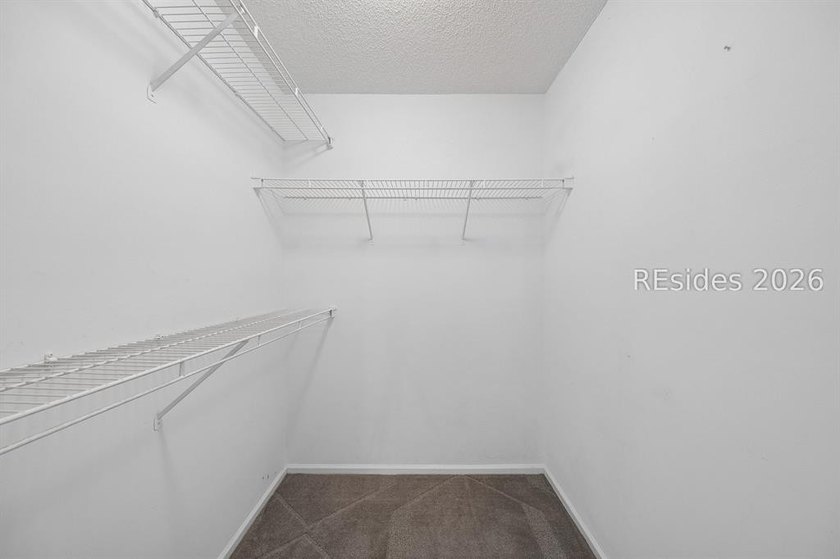 Enjoy wooded views from this second-floor condominium in The - photo 12