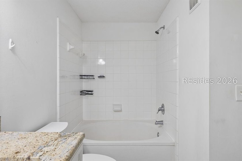 Enjoy wooded views from this second-floor condominium in The - photo 14